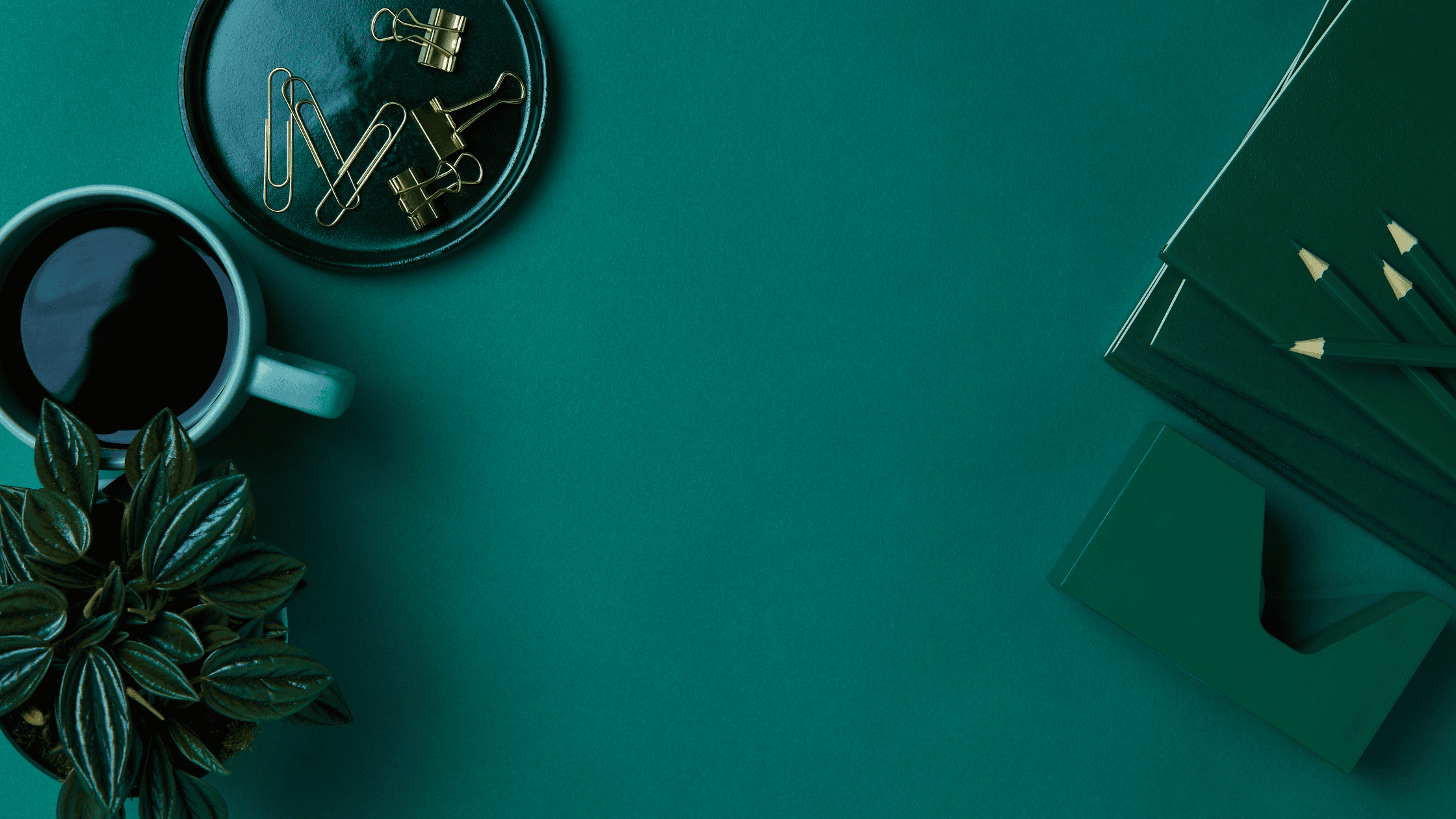 Green desk, notebook, pencils