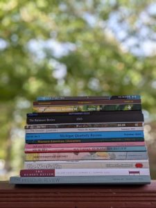 stack of magazines outside with trees in the background